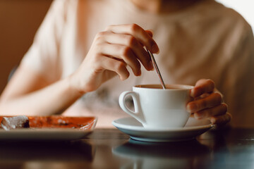 Young beautiful smiling woman enjoying drinking cappuccino coffee cup indoor cafe. Tea or coffee drink mug