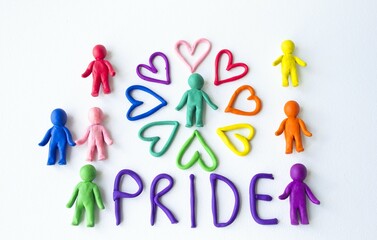 On a white background, the inscription pride multi-colored men and plasticine hearts, a symbol of love and unity.  Gay pride LGBT community, equal rights movement and gender equality life concept. 