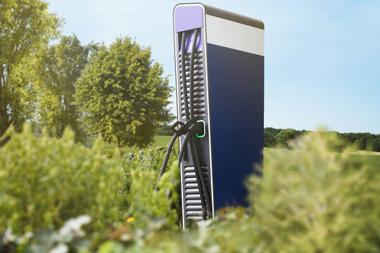 electric fuel charge station for plug in e mobility cars to get power from terminal directly to filler neck filling stations stand in nature next to trees at sunny day