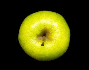 green apple lies on a black background