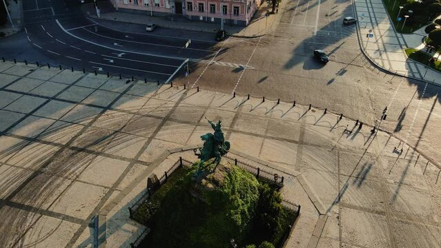 AERIAL: Bogdan Khmelnitsky Monument with Mykhailivsky Monastery on the background at dawn. Drone view.
