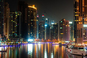 Dubai city at night, reflection of lights on the surface of the water.  urban landscape