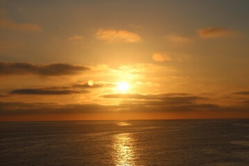 Naklejka na ściany i meble Orange sunset over the ocean