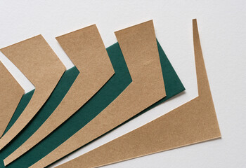 deconstructed paper on dark green and white paper