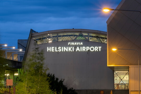 Helsinki-Vantaa Airport, operated by Finavia, terminal 2 exteriors at night. Dark storm clouds in the background.