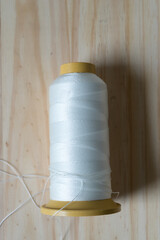spool of thread on a wooden background