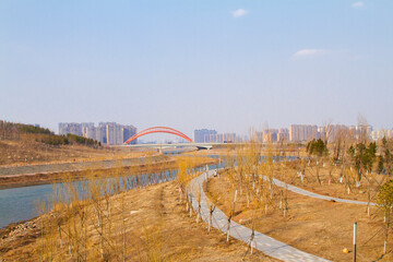Fototapeta na wymiar Changchun, Jilin, China - April 20 2021: Yitong river and modern bridge architecture in Spring.