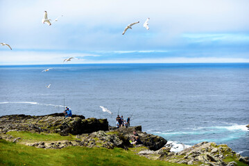 fishing on the Atlantic Ocean from high cliffs, Ireland. City of Limerick , 09 July 2022