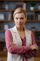 Portrait of beautiful blondie woman looking at camera and smiling. Adult stylish businesswoman at workplace in office. Successful confident female leader close up face headshot, front portrait