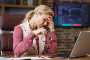 Depressed businesswoman overworked on laptop computer. Tired worker recieved bad online news....
