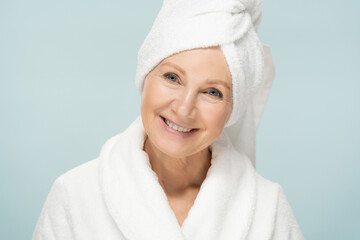 Beauty portrait of mature woman in bathrobe after spa, older beauty face with fresh skin - obrazy, fototapety, plakaty