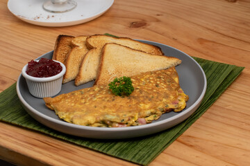 Omellete with toast and jam for breakfast