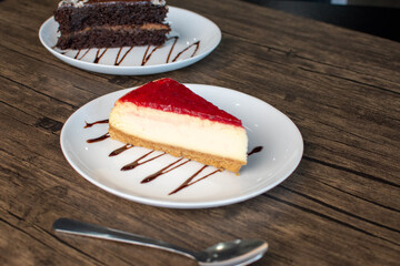Strawberry Cheesecake with chocolate in a wood table and spoon