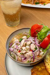 Close up fish ceviche with drink and tomato salad
