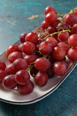 Close up of red grapes on a white bowl