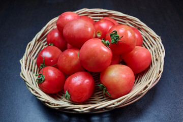 Red tomatoes in a wicker basket