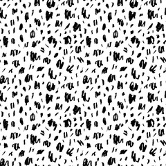Seamless pattern with charcoal blots and strokes. Black painted different dots. Chaotic ink brush scribbles decorative texture. Messy black pencil doodles. Speckles of different size texture. 