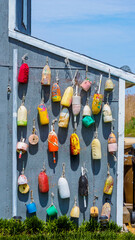 Buoys on a seaside home that are multicolored as a nautical display