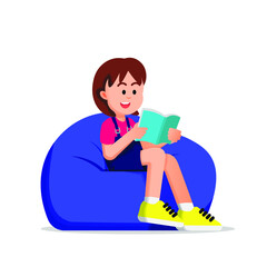 cute boy reading a book and sitting on a beanbag
