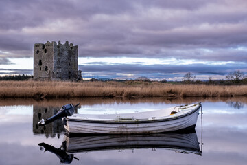 Boat moored on the river dee with Threave Castle in the background, Scotland
