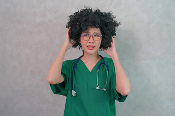 Portrait Of Smiling Female Doctor Wearing Green uniform With Stethoscope In Hospital Office,...