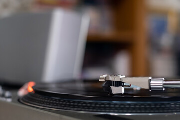 Fototapeta na wymiar The Headshell Cartridge and Stylus of Classic Vintage Vinyl Record Player Playing on Vinyl Record Music