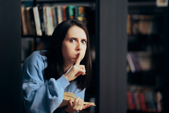 Upset Woman Making Silence Shh Sign In A Library. Annoyed Irritated Person Complaining About Noise In A Reading Rook
