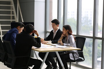 Young Asian business team people meeting in office
