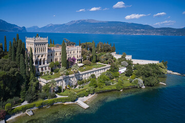Historic Venetian Neo-Gothic villa on Lake Garda. Panorama of Garda Island located on Lake Garda in Italy. Aerial view of the island of Garda.