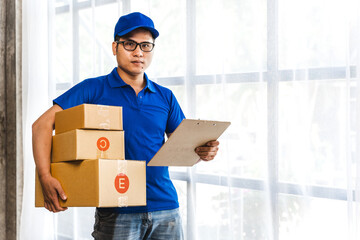 Asian delivery man holding package boxes in front.