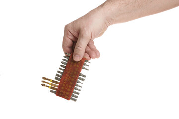 Hand holds a set of bits for a screwdriver on a white background - 516110451