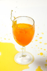 A dice falling into a glass of orange liquid caused a splash - 516110456