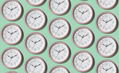 A pattern of a large number of large wall clocks on a light background.