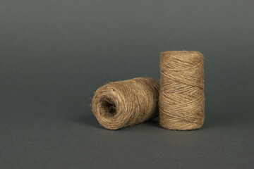 Fototapeta na wymiar Two skeins with coarse threads on a dark gray background.