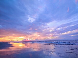 Fototapeta na wymiar Multicolored Beach Ocean Sunrise Cloudscape and Reflecting Waters