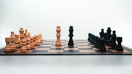 A chess board isolated on a white background with the kings in the center. Leader confrontation....