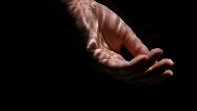 Lifeless hand floating under water on a black background. Rescue of drowning concept.