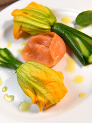 Plate with fried zucchini flowers with a slice of smoked salmon, High quality photo