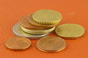 Euro coins and euro cents on genuine leather.