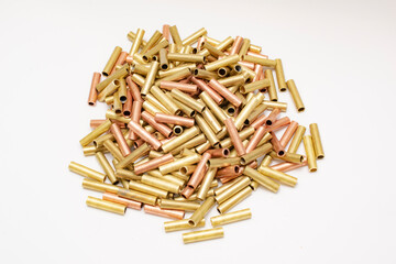pile of copper pipes on a white background