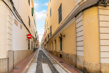 A long straight narrow alley in the Old Town section of Mao or Mahon Spain, on the Balearic island of Menorca in the Mediterranean Sea.