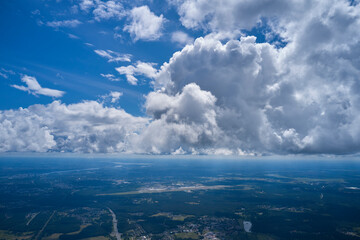 Cumulus storm clouds in blue sky. Beautiful spring landscape with cloudy skyline, aerial view from...