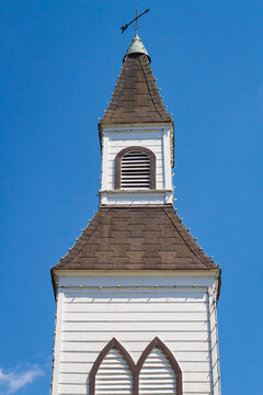 Beautiful traditional church in rural. Exterior of a Little White Country Church on a Sunny Day and blue sky background