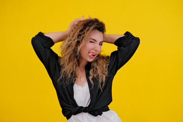 beautiful girl on a yellow background. Pretty brave woman showing wild devilish side making bull...