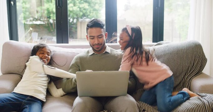 Father Typing On Laptop While ADHD Mental Disorder Daughters Jump On Home Sofa. Single Parent Feeling Stressed, Struggling To Work With Hyperactive Girls. Naughty Children Misbehaving With Sugar Rush