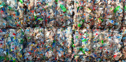 Close-up of a pile of compressed plastic waste at a waste recycling plant