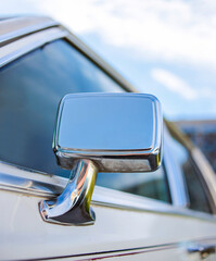 Classic car background. Close-up of the side mirror of a classic design. Vintage car wallpaper....