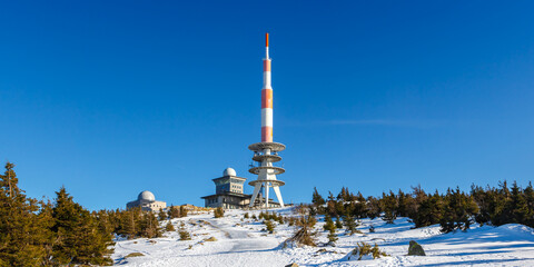 Brocken mountain peak in Harz with snow in winter panorama in Germany