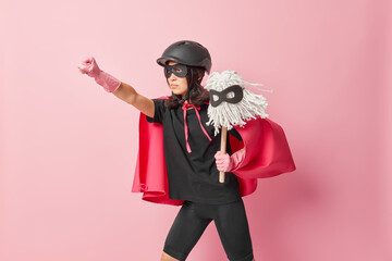 Superhero woman feels powerful stretches arm and clenches fist prepares for flight and clean your...