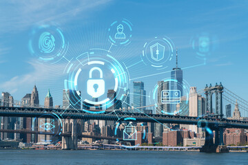 Brooklyn and Manhattan bridges with New York City financial downtown skyline panorama at day time over East River. The concept of cyber security to protect confidential information, padlock hologram